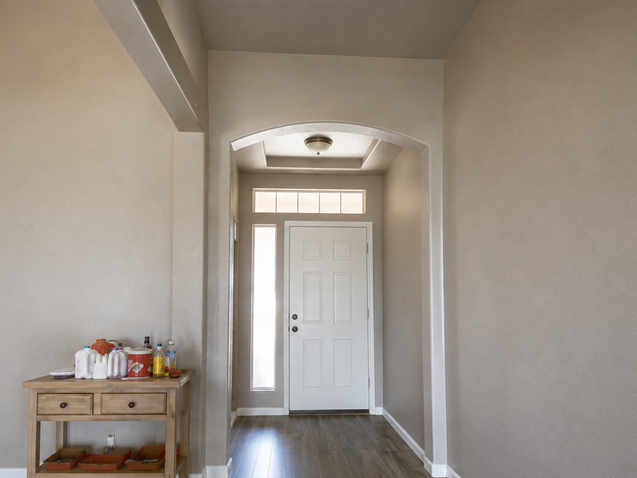 Freshly painted interior entryway and hallway with neutral walls, white trim, and arched doorways in a Fernley NV home