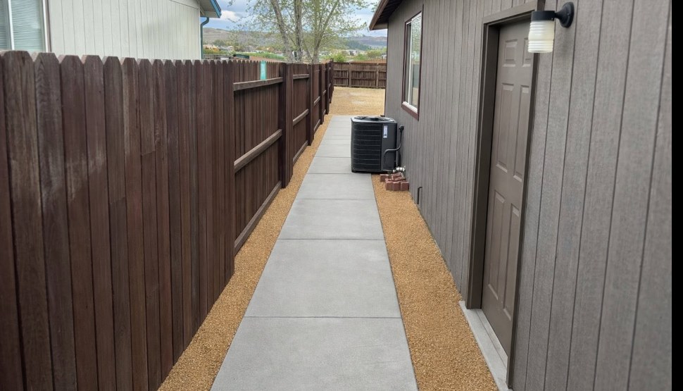 After: finished concrete side yard walkway with gravel borders at a Fernley Nevada home