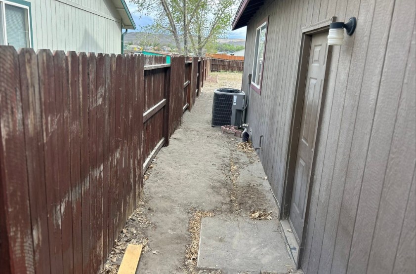 Before: narrow side yard in Fernley NV with uneven dirt, debris and no walkway